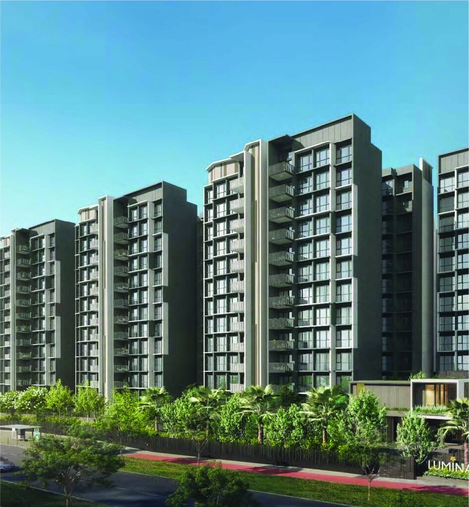 Modern high-rise apartment buildings with balconies, set against a clear blue sky and landscaped foreground.