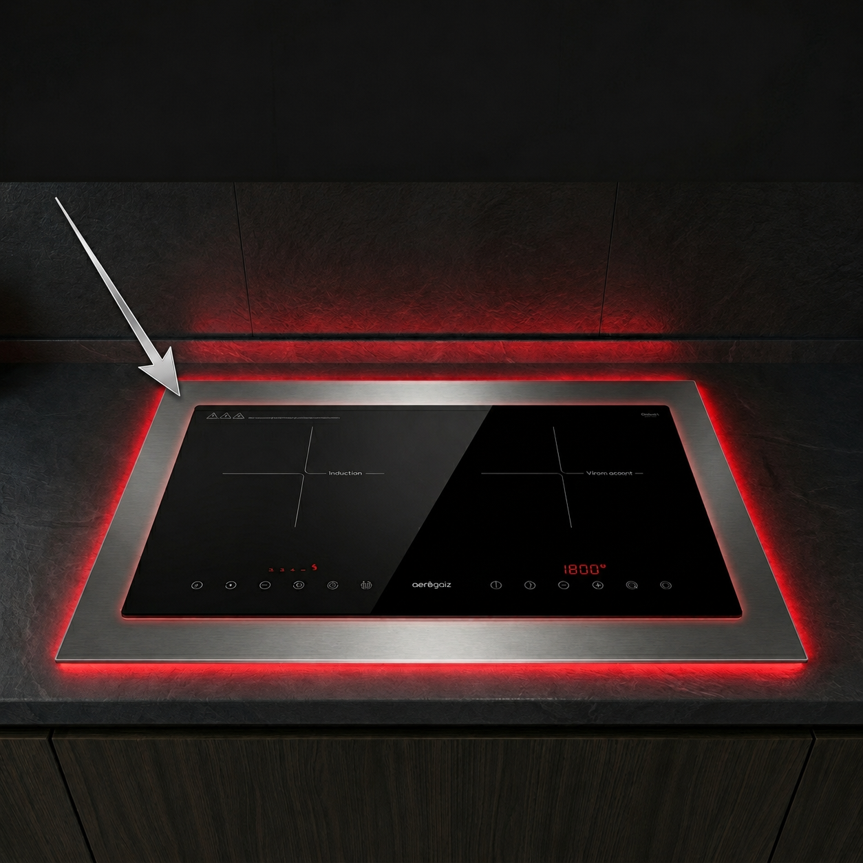 Induction cooktop with a red underglow and touch controls, seen in a sleek kitchen island.