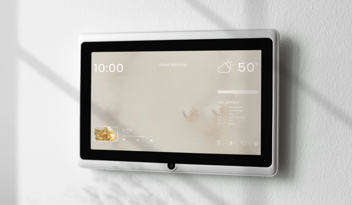 Wall-mounted smart display showing time (10:00) and current weather (50°F) with a calendar/music widget on screen