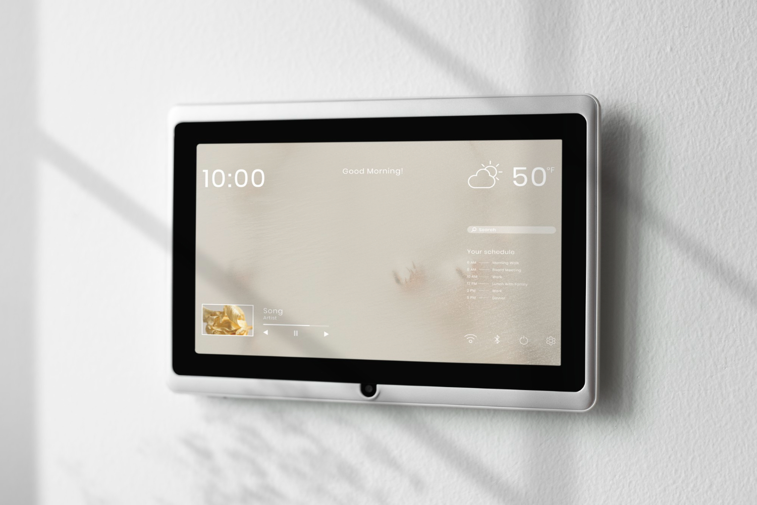 Wall-mounted smart display showing time (10:00) and current weather (50°F) with a calendar/music widget on screen