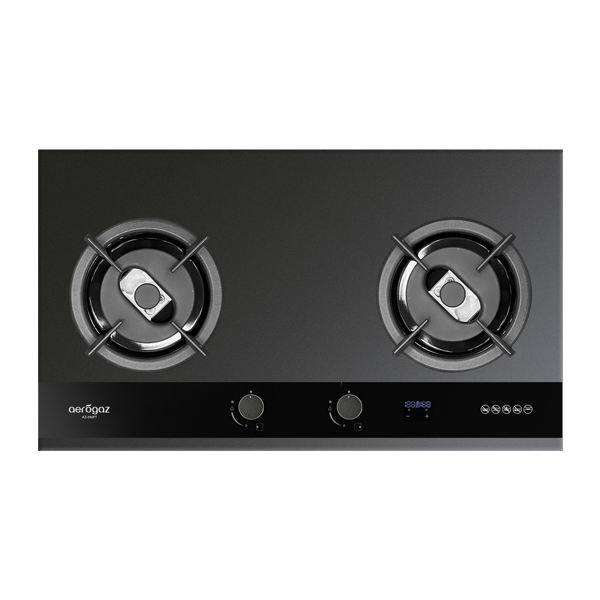 Two-burner gas cooktop with metal trivets on a dark glass surface and a black control panel along the front edge.